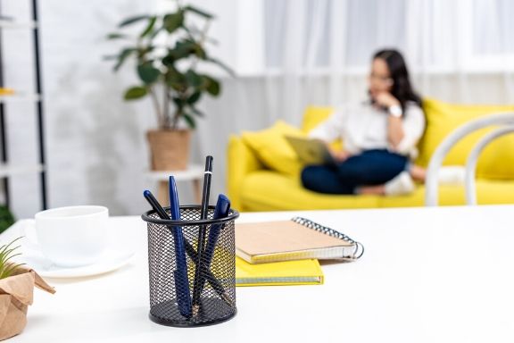 entrepreneur working from her home office/guest room sofa 